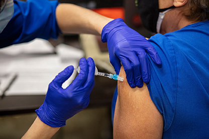 A patient receives the COVID-19 vaccine at NCH.