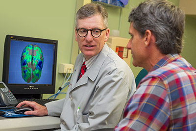 Shaun O'Leary, M.D., Ph.D. talks with a patient.